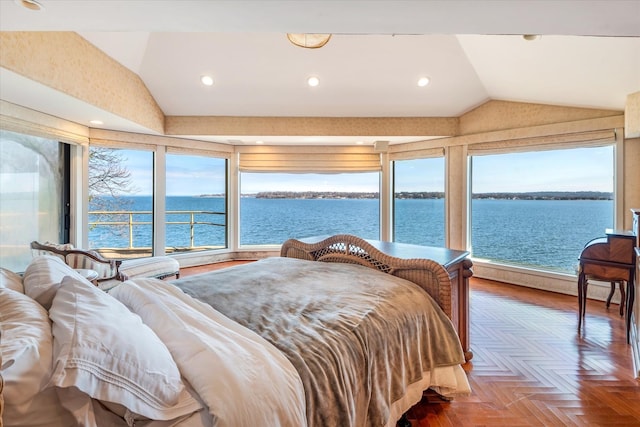 bedroom with multiple windows, a water view, lofted ceiling, and recessed lighting