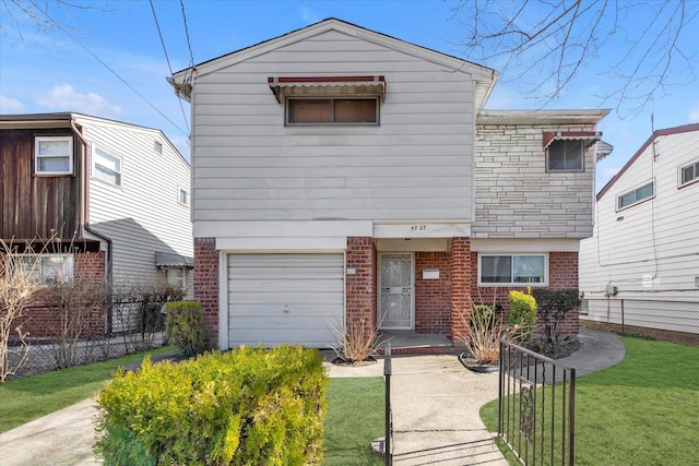 view of front of home featuring brick siding, a garage, and fence