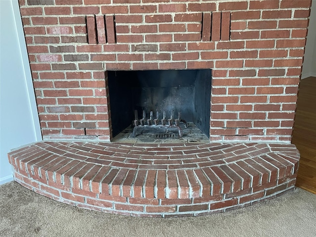 room details with a brick fireplace and carpet floors