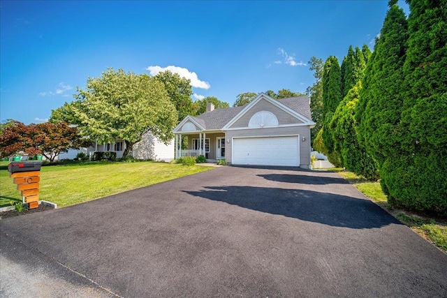 10 Lyford Ln, Poughkeepsie, NY 12601 - view of front of house with driveway, a front yard, an attached garage, a chimney, and a porch