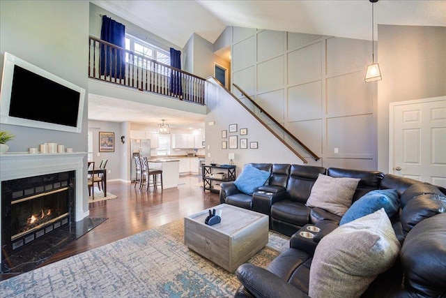 10 Lyford Ln, Poughkeepsie, NY 12601 - living room featuring high vaulted ceiling, dark wood-style flooring, and stairs