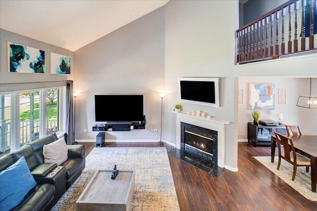 10 Lyford Ln, Poughkeepsie, NY 12601 - living room featuring high vaulted ceiling, dark wood-type flooring, and a fireplace with flush hearth