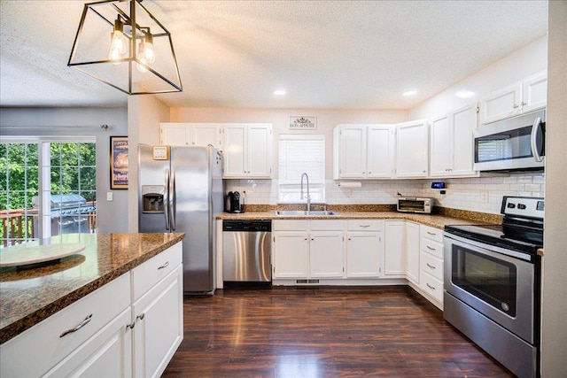 10 Lyford Ln, Poughkeepsie, NY 12601 - kitchen featuring stainless steel appliances, white cabinetry, tasteful backsplash, dark wood-style flooring, and recessed lighting