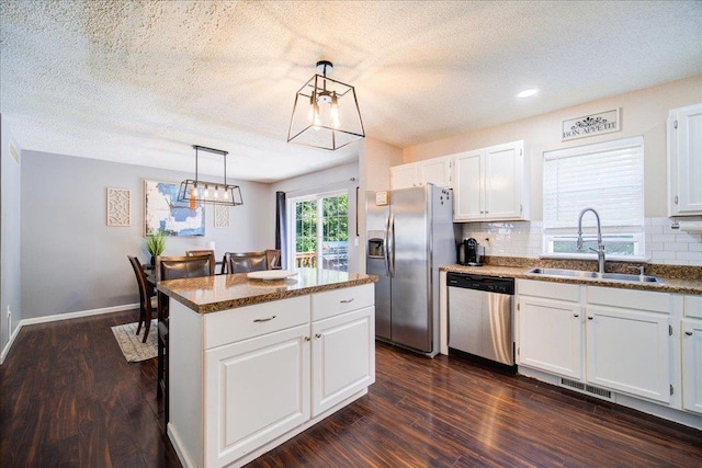 10 Lyford Ln, Poughkeepsie, NY 12601 - kitchen featuring stainless steel appliances, white cabinetry, decorative backsplash, a center island, and dark wood-type flooring
