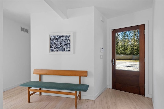 entrance foyer featuring visible vents, baseboards, and hardwood / wood-style floors