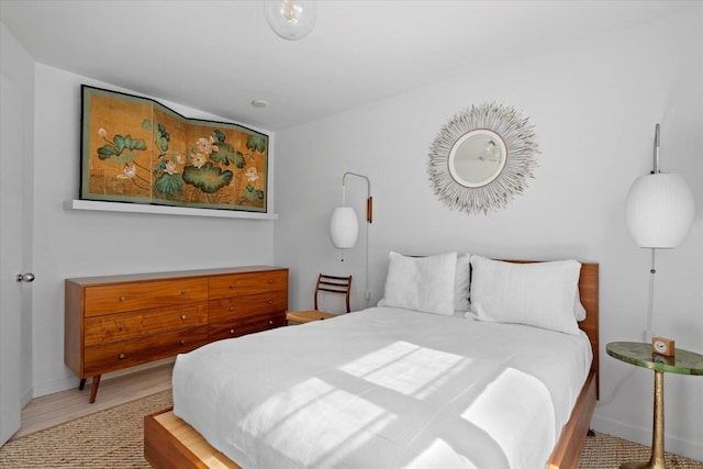 bedroom featuring baseboards and wood finished floors