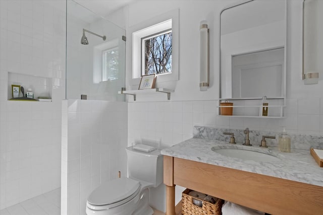 full bath with vanity, walk in shower, tile walls, toilet, and tasteful backsplash