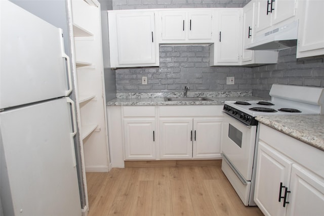 kitchen featuring white cabinetry, white appliances, under cabinet range hood, and a sink