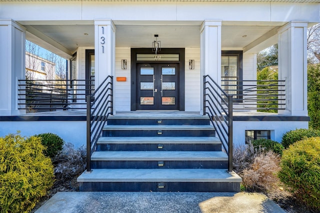 view of exterior entry featuring a porch