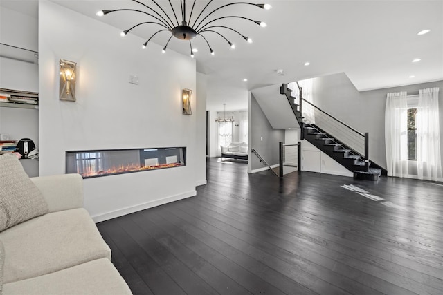 living room with baseboards, a multi sided fireplace, stairs, hardwood / wood-style floors, and recessed lighting