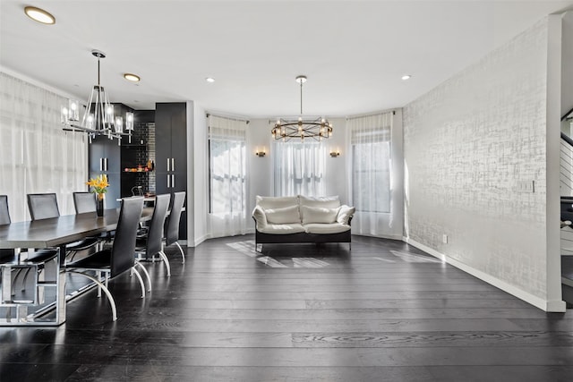 dining room featuring hardwood / wood-style flooring, a wealth of natural light, and a chandelier