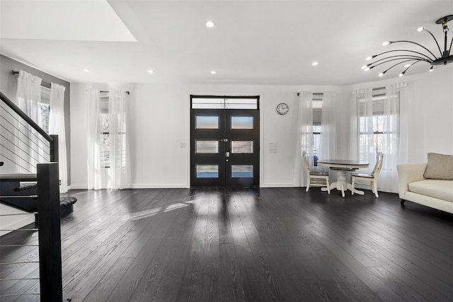 entrance foyer featuring a chandelier, stairs, hardwood / wood-style floors, recessed lighting, and french doors