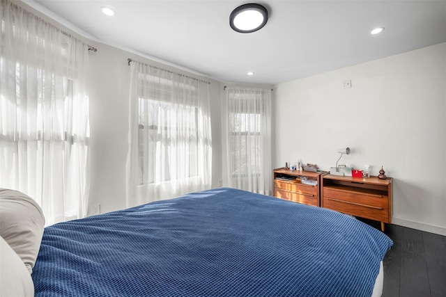 bedroom with recessed lighting, baseboards, and wood finished floors