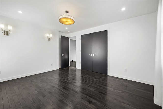 unfurnished bedroom featuring a closet, recessed lighting, baseboards, and dark wood-style flooring