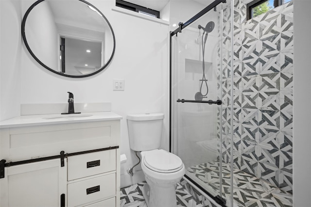 full bathroom with vanity, toilet, and a shower stall