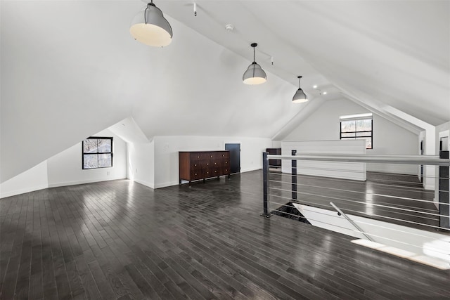 additional living space featuring vaulted ceiling, wood finished floors, and baseboards