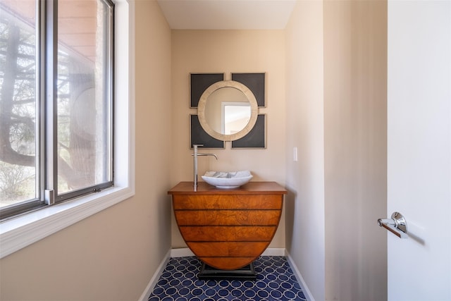 bathroom featuring baseboards and vanity