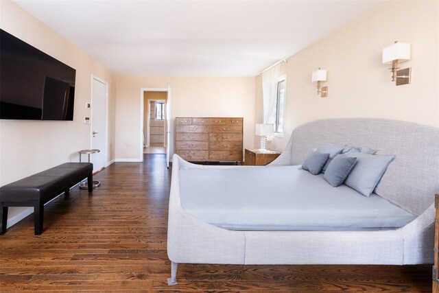 bedroom featuring baseboards and wood finished floors