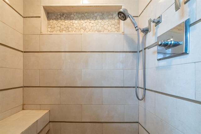 full bath featuring a tile shower