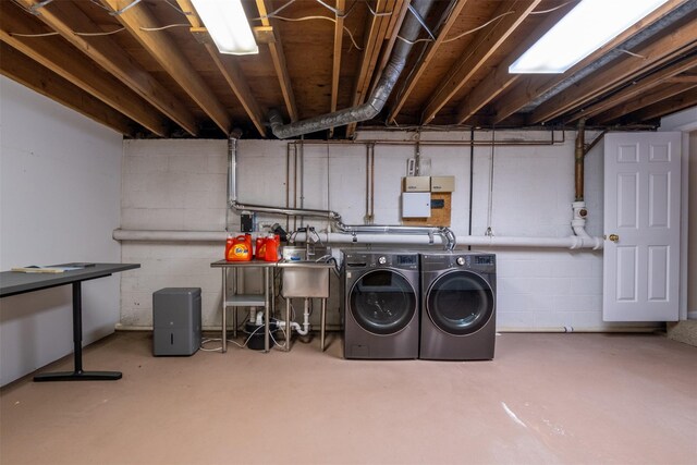 clothes washing area with laundry area and washer and clothes dryer