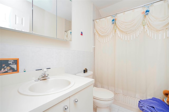 bathroom with vanity, tile walls, toilet, and a shower with curtain