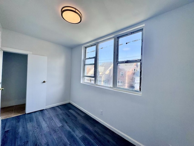 94-17 42nd Ave, Elmhurst, NY 11373 - unfurnished bedroom featuring dark wood-style flooring and baseboards