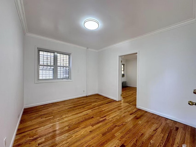 94-17 42nd Ave, Elmhurst, NY 11373 - empty room with wood finished floors, ornamental molding, and baseboards