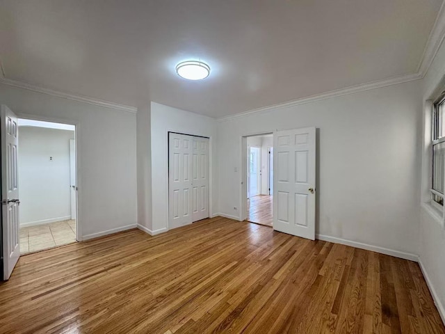 94-17 42nd Ave, Elmhurst, NY 11373 - unfurnished bedroom featuring ornamental molding, a closet, and light wood-style flooring