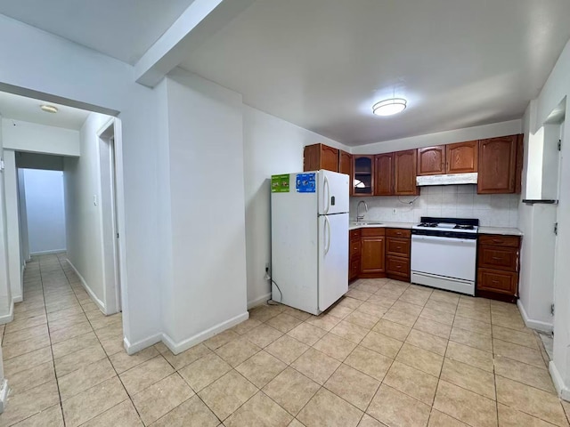 94-17 42nd Ave, Elmhurst, NY 11373 - kitchen featuring a sink, under cabinet range hood, light tile patterned floors, white appliances, and light countertops