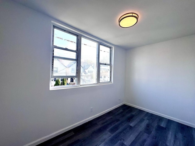 94-17 42nd Ave, Elmhurst, NY 11373 - empty room featuring dark wood-type flooring, plenty of natural light, and baseboards