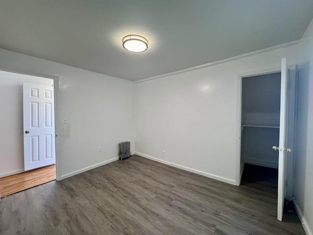 94-17 42nd Ave, Elmhurst, NY 11373 - interior space featuring dark wood-style floors, baseboards, and radiator heating unit