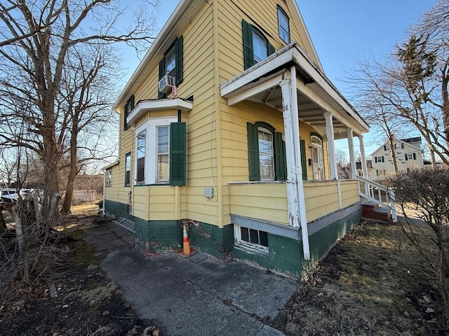 view of side of home featuring a porch