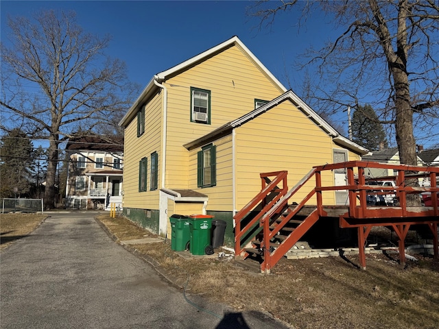 rear view of property featuring a deck