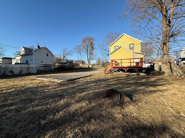 view of yard featuring stairway, a deck, and fence