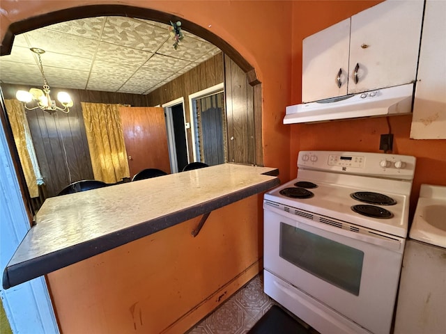 119 Verplanck Ave, Beacon, NY 12508 - kitchen with electric stove, under cabinet range hood, a sink, arched walkways, and a chandelier