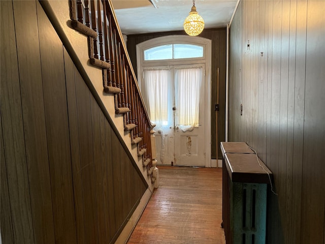 119 Verplanck Ave, Beacon, NY 12508 - doorway with stairs, light wood-type flooring, and wood walls