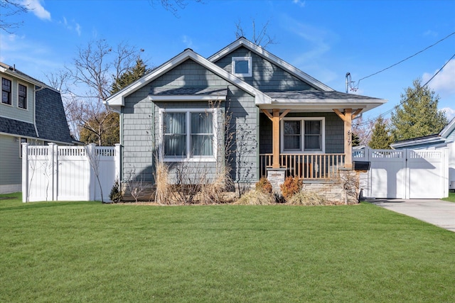 view of front of house with fence, a porch, a front lawn, and a gate