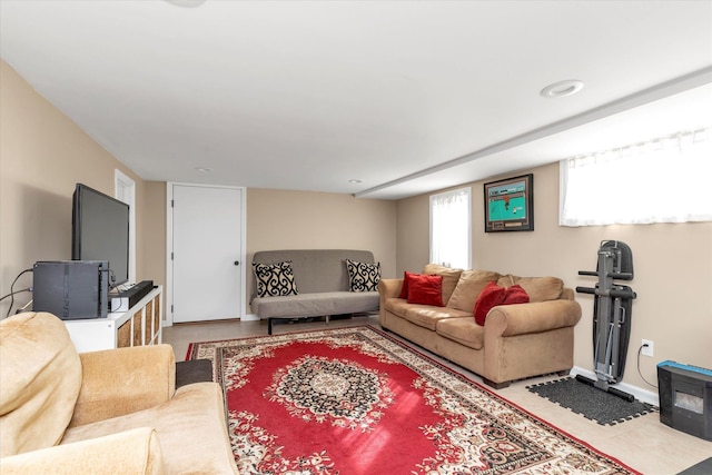 living room with baseboards and tile patterned flooring