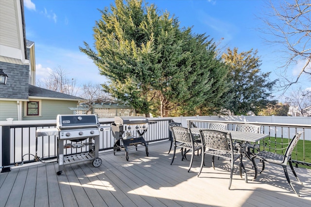 wooden deck featuring outdoor dining area and grilling area