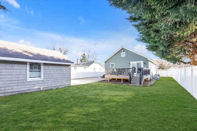 back of house featuring a wooden deck, a lawn, a fenced backyard, and a patio area