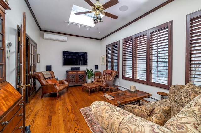 living room with a ceiling fan, a wall mounted AC, wood finished floors, crown molding, and baseboard heating