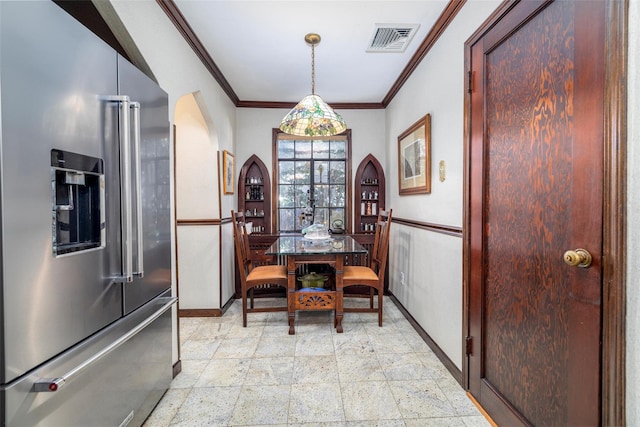 dining area featuring baseboards, visible vents, and ornamental molding