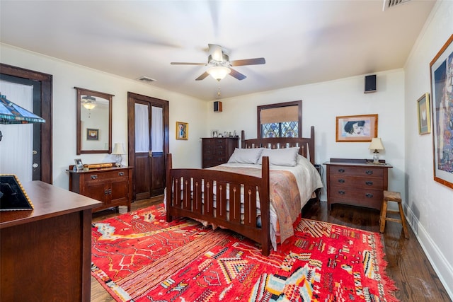 bedroom with visible vents, baseboards, dark wood-style floors, and a ceiling fan