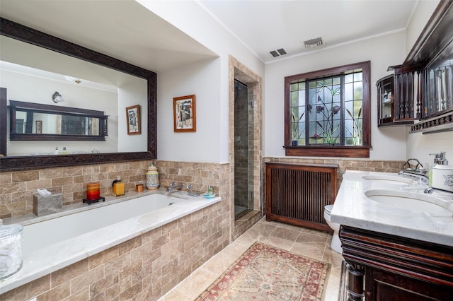 bathroom with visible vents, a shower stall, a garden tub, and a sink