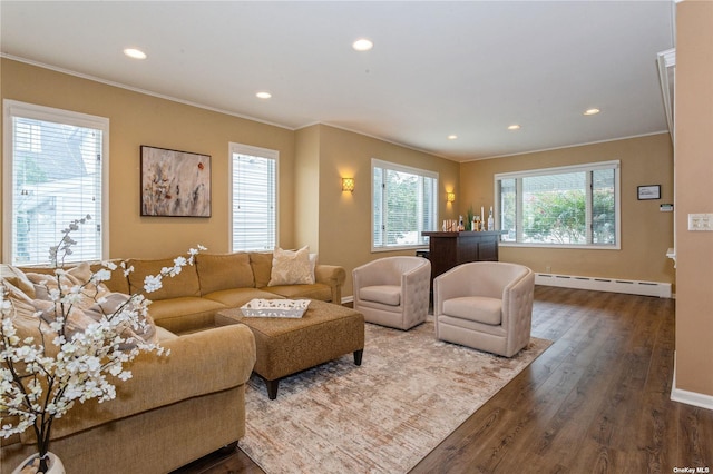 living room featuring dark wood-type flooring, ornamental molding, a baseboard heating unit, recessed lighting, and baseboards