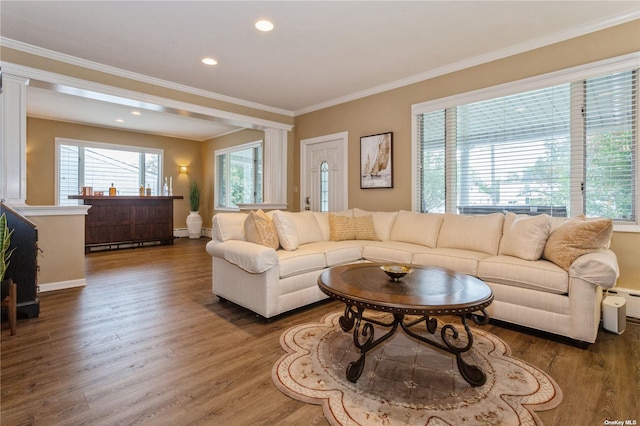 living room with crown molding, baseboards, baseboard heating, recessed lighting, and wood finished floors