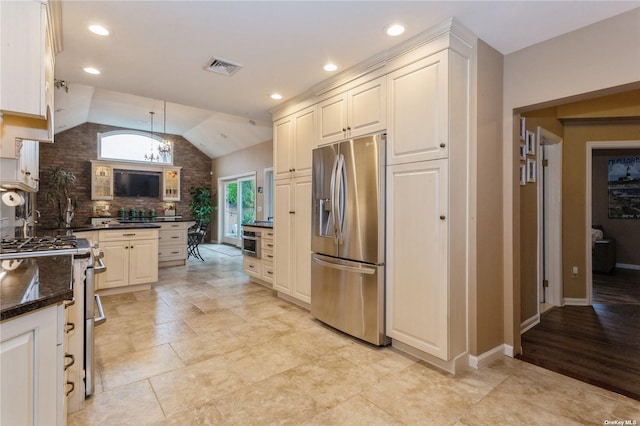 kitchen featuring visible vents, stainless steel appliances, decorative backsplash, lofted ceiling, and hanging light fixtures