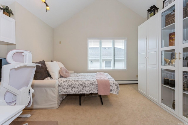 bedroom with light carpet, baseboard heating, and vaulted ceiling