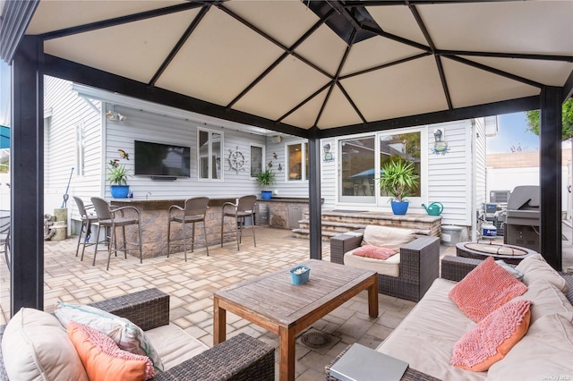 view of patio featuring outdoor dry bar, a grill, and outdoor lounge area