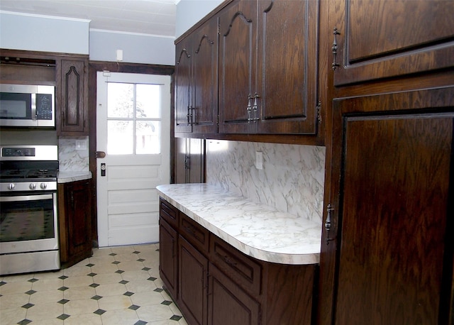 kitchen with backsplash, stainless steel appliances, dark brown cabinetry, light countertops, and light floors